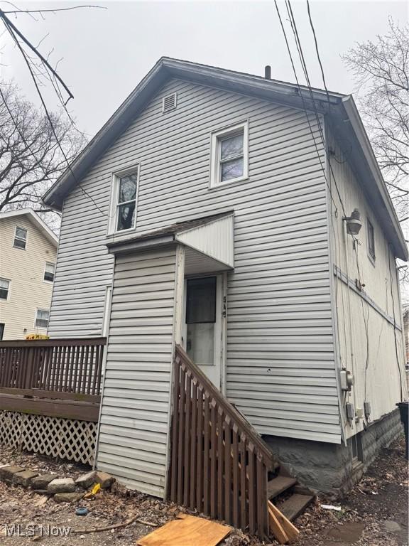 back of property with a wooden deck