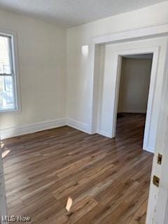 spare room with dark hardwood / wood-style floors