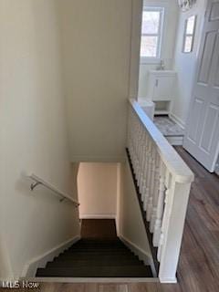 stairs featuring hardwood / wood-style floors