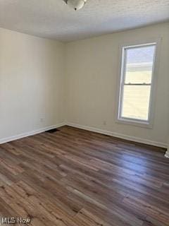 unfurnished room featuring dark wood-type flooring