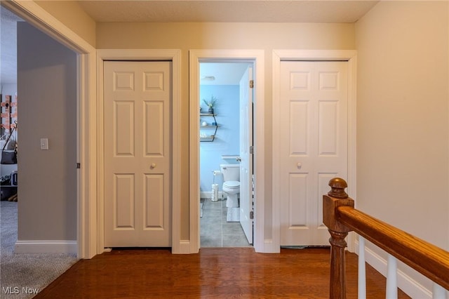 corridor featuring dark hardwood / wood-style floors