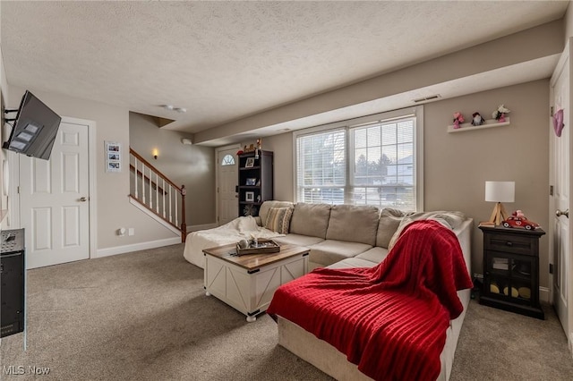 living room featuring carpet and a textured ceiling