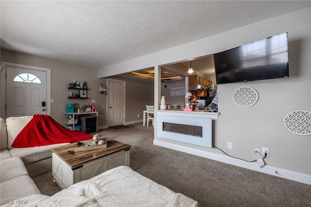 living room featuring carpet and a textured ceiling