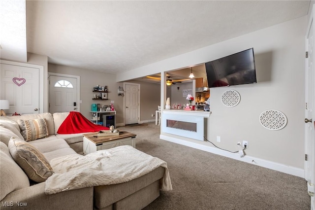 living room featuring carpet floors and ceiling fan