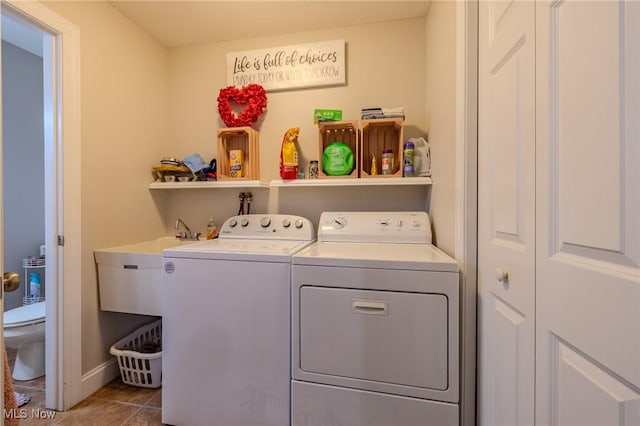 laundry room featuring sink, tile patterned flooring, and separate washer and dryer