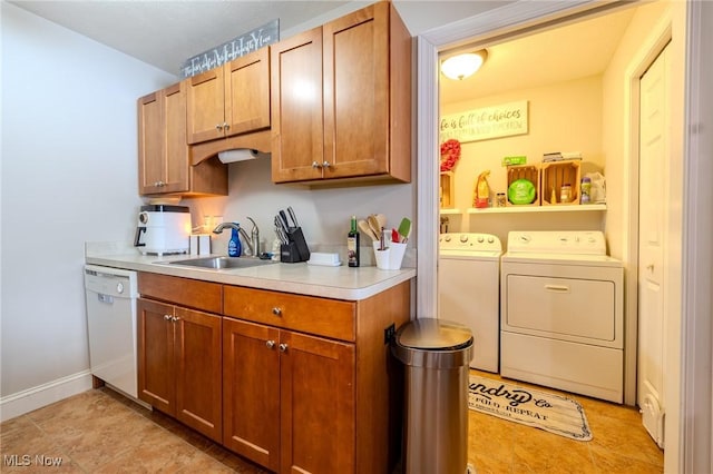 clothes washing area with sink and separate washer and dryer