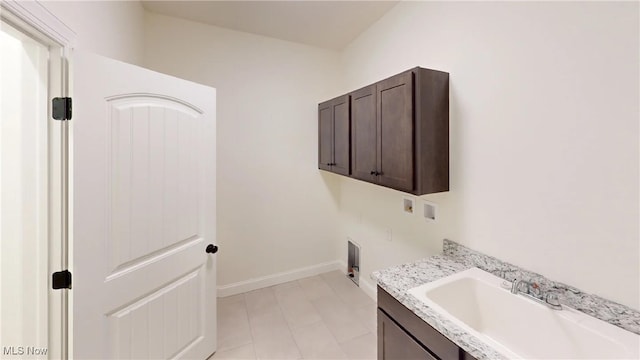 laundry area with sink, cabinets, hookup for a washing machine, and electric dryer hookup