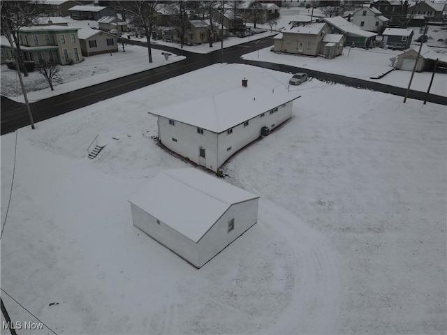 snowy aerial view with a residential view