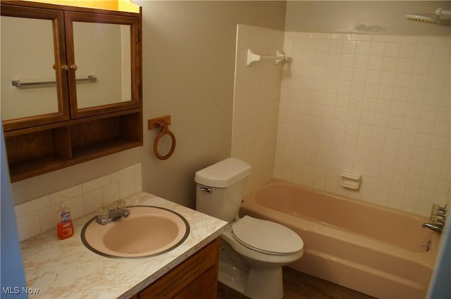 bathroom featuring shower / bath combination, vanity, and toilet