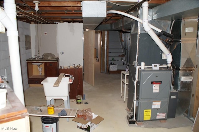 unfinished basement with heating unit and concrete block wall