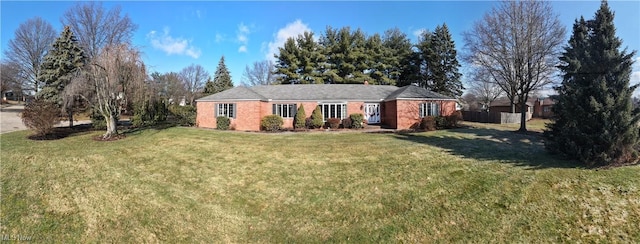 ranch-style home with a front lawn