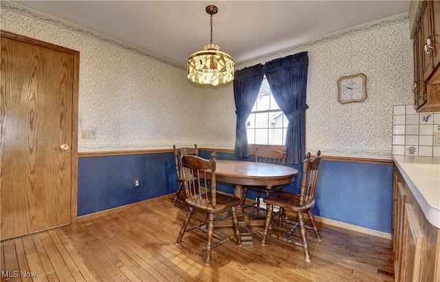 dining room featuring ornamental molding and hardwood / wood-style flooring