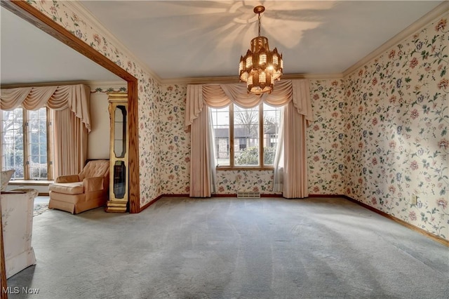 carpeted empty room with crown molding and an inviting chandelier