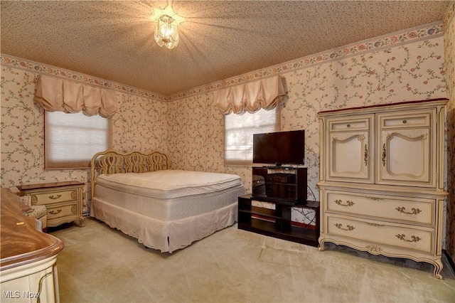 bedroom with carpet floors and a textured ceiling