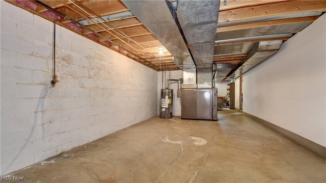 basement featuring heating unit and water heater