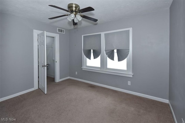 interior space with ceiling fan and a textured ceiling