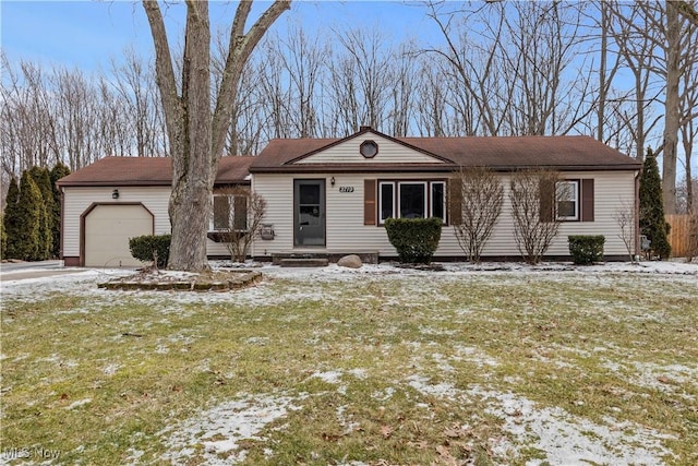 view of front of house featuring a garage and a lawn