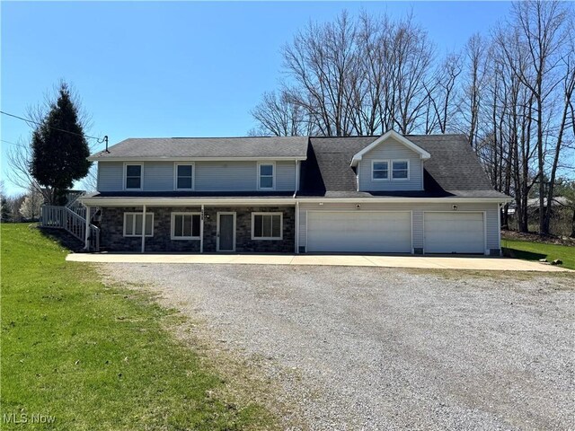 8961 Herbert Rd, Canfield, OH 44406 - traditional-style home with stone siding, driveway, a front yard, and a garage