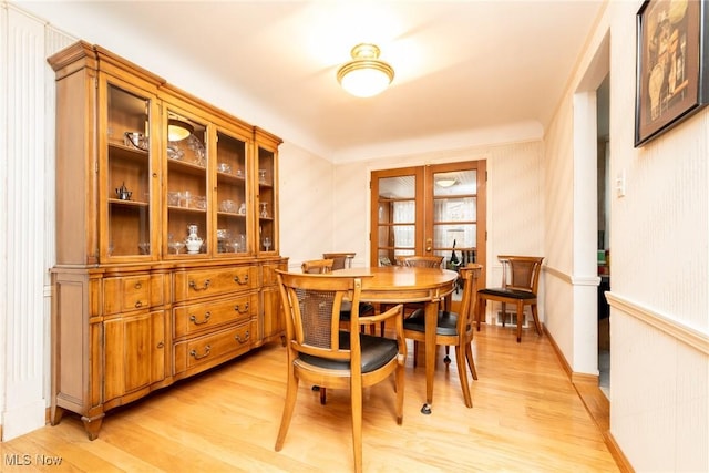 dining space featuring light wood-type flooring and french doors