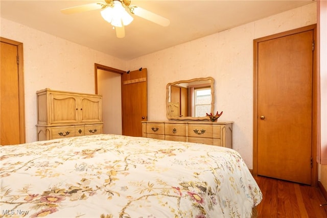 bedroom with ceiling fan and dark wood-type flooring