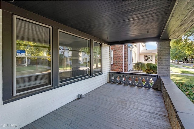 wooden terrace featuring covered porch