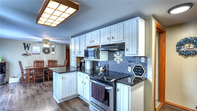 kitchen featuring appliances with stainless steel finishes, decorative backsplash, dark hardwood / wood-style flooring, white cabinetry, and kitchen peninsula