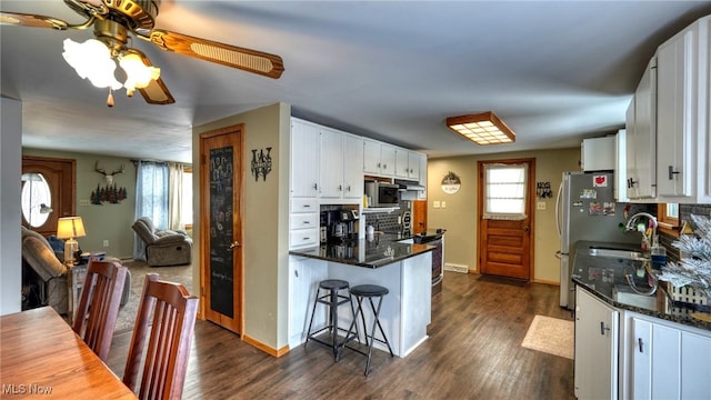 kitchen with white cabinetry, dark wood-type flooring, appliances with stainless steel finishes, and sink