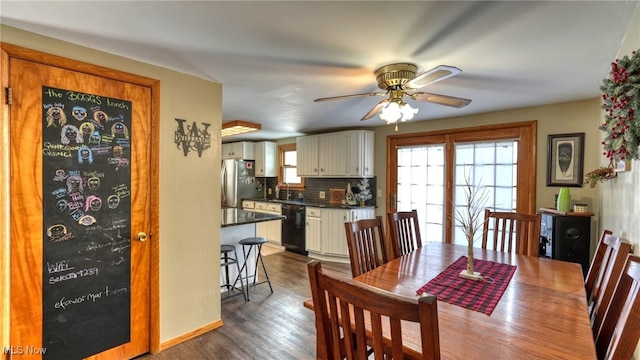 dining space featuring ceiling fan, sink, and dark hardwood / wood-style flooring