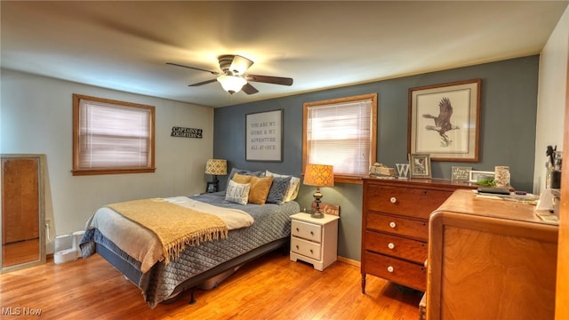 bedroom featuring light wood-type flooring and ceiling fan