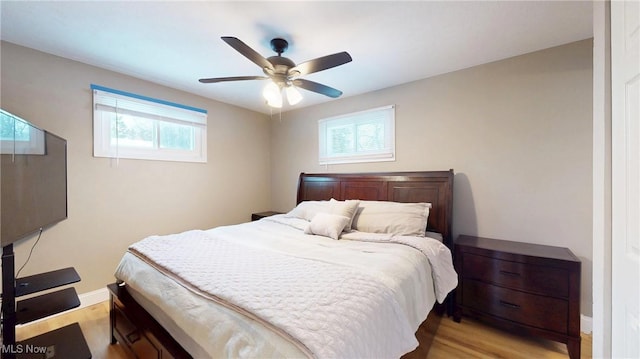 bedroom with light wood-type flooring and ceiling fan