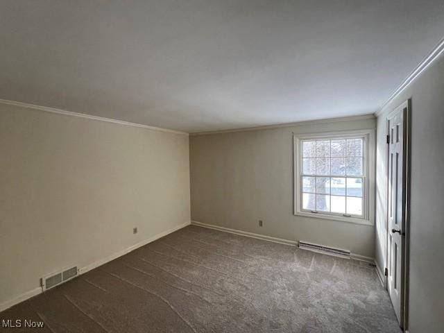 empty room featuring dark carpet, ornamental molding, and a baseboard heating unit