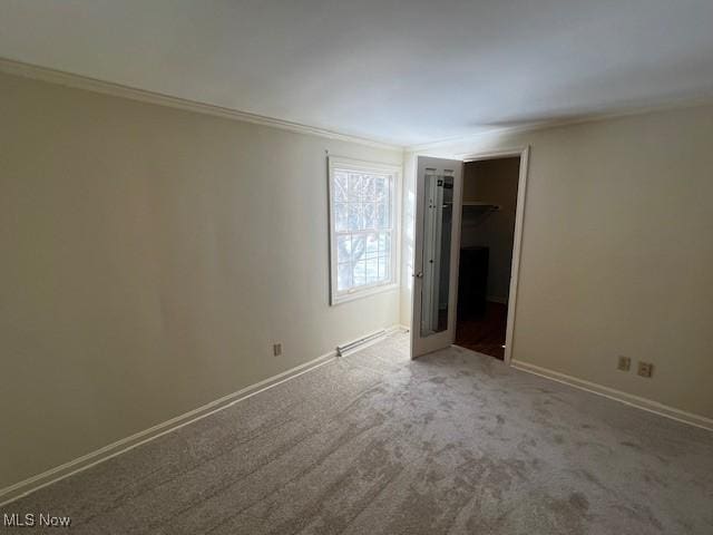 unfurnished bedroom featuring crown molding and carpet floors