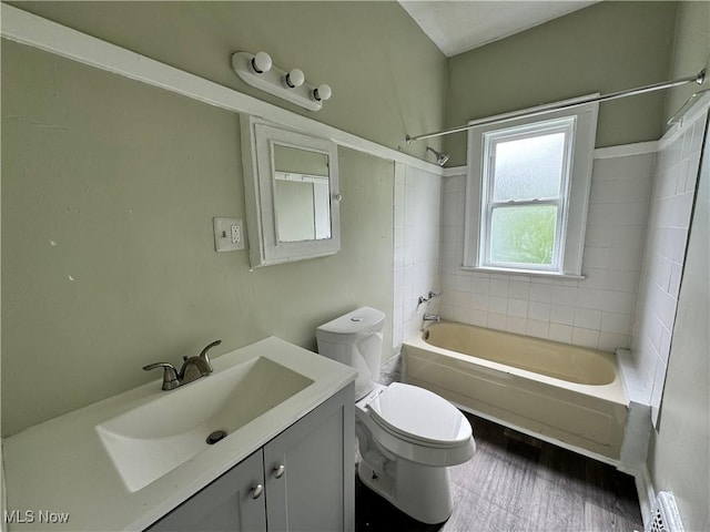 full bathroom with tiled shower / bath combo, vanity, and toilet