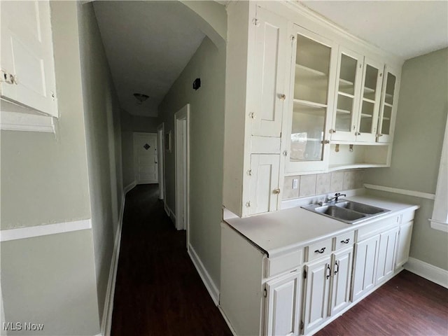 kitchen with sink, dark wood-type flooring, and white cabinets