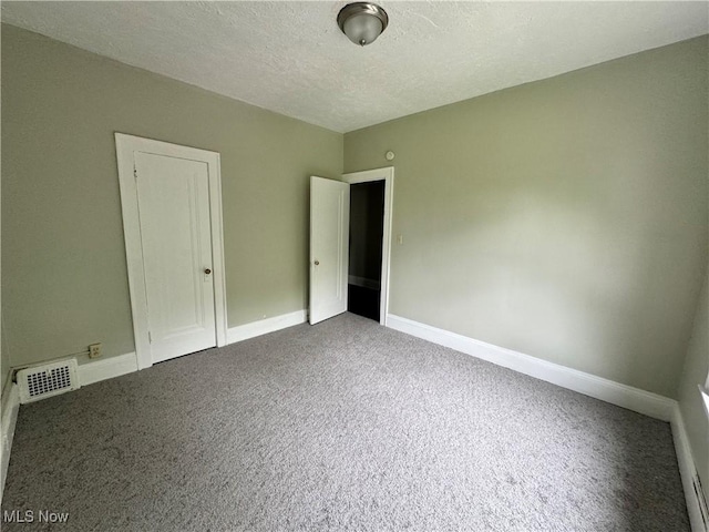 unfurnished bedroom featuring carpet floors and a textured ceiling