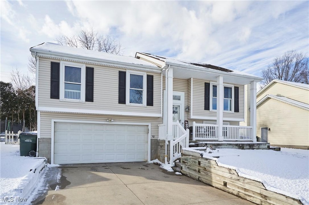 bi-level home with a garage and covered porch