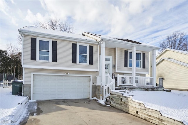 bi-level home with a garage and covered porch