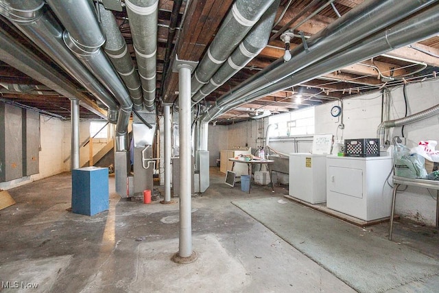 basement with washing machine and dryer and heating unit