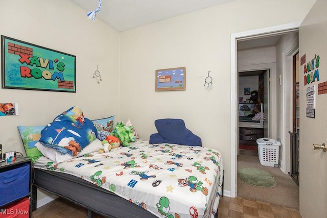 bedroom featuring parquet flooring