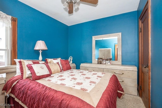 bedroom with light colored carpet and ceiling fan