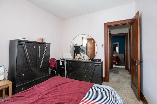 bedroom featuring light colored carpet