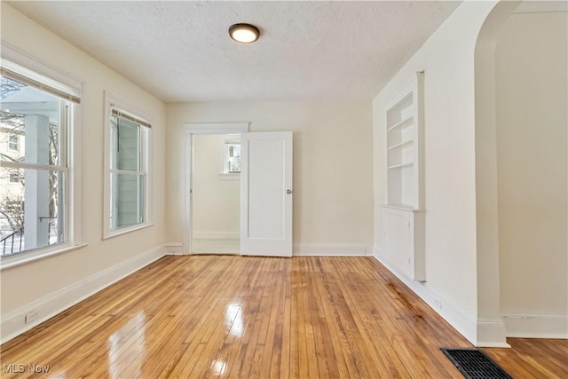 foyer with light hardwood / wood-style floors and a textured ceiling