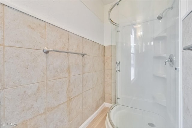 bathroom with a shower with shower door