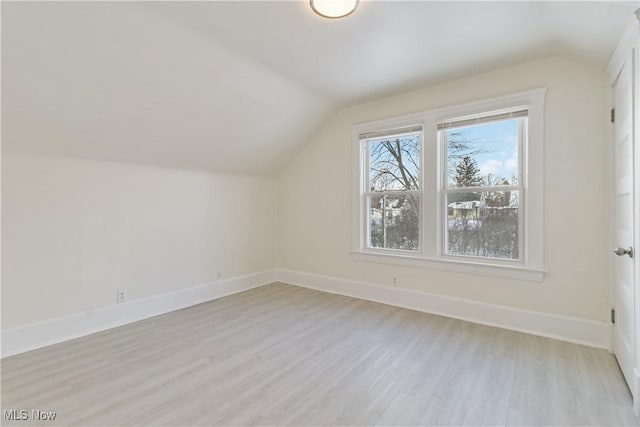 bonus room with lofted ceiling and light hardwood / wood-style flooring