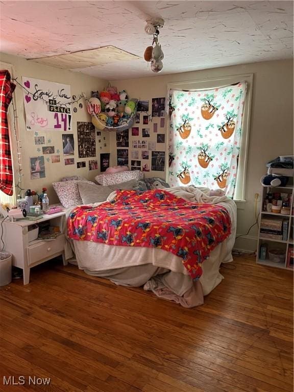 bedroom with dark wood-type flooring