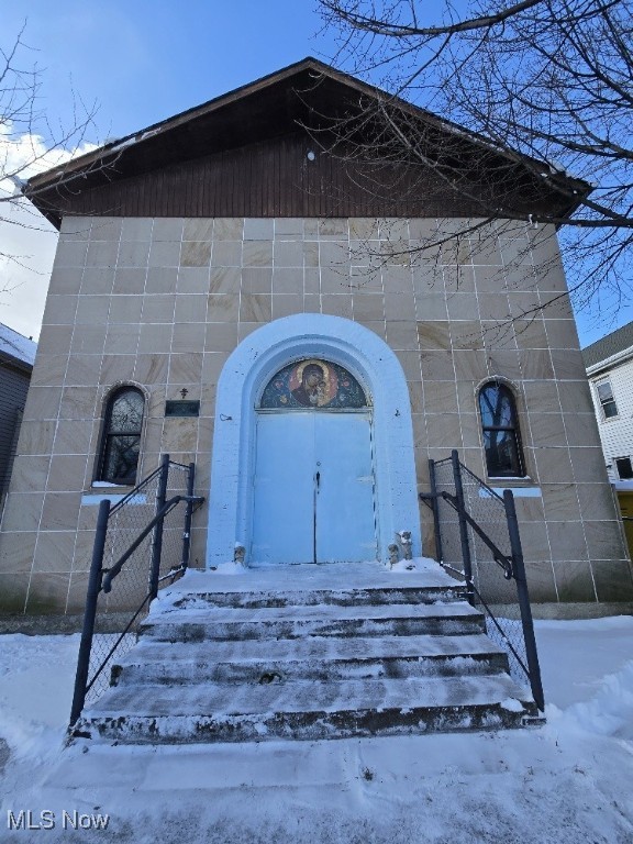 view of snow covered property entrance