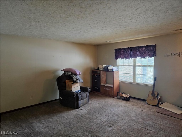 unfurnished room featuring carpet floors, visible vents, baseboards, and a textured ceiling