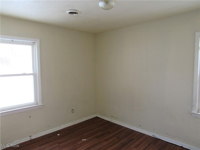 spare room with dark hardwood / wood-style flooring