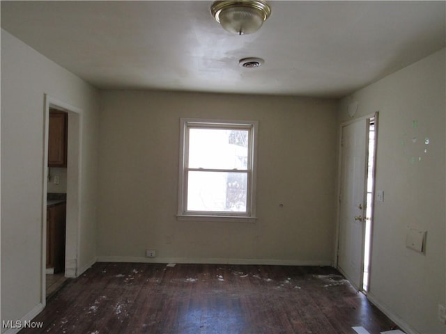 unfurnished room with dark hardwood / wood-style floors