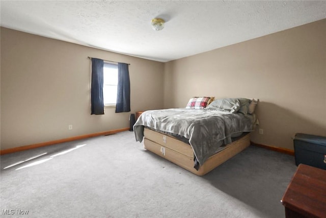 carpeted bedroom with a textured ceiling